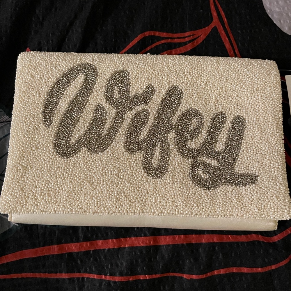 NWT Beaded clutch spells “Wifey". Comes with chain
